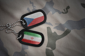 vintage army blank, dog tag with flag of czech republic and iran on the khaki texture background....