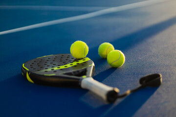 Padel tennis racket. Background with copy space. Sport court and ball
