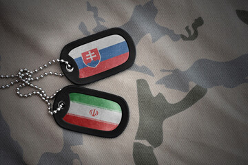 vintage army blank, dog tag with flag of slovakia and iran on the khaki texture background....