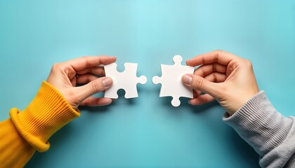 Two hands assemble jigsaw puzzle pieces. Collaboration concept. People work together to achieve solution. Cooperation, teamwork for success. Creative partnership. Problem solving. Building something