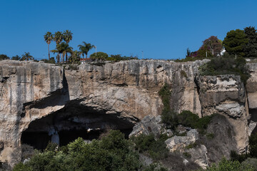 In north of Neapolis Archaeological Park is Paradise stone quarry (Latomia del Paradiso). Today it is a beautiful garden with Mediterranean vegetation and numerous caves. Syracuse, Sicily, Italy.
