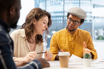 Realtor experts team meeting with entrepreneur to evaluate the office space layout, planning an office relocation using architectural plans. Business woman shares her vision of the startup.