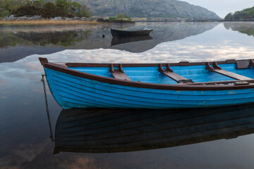 Obraz premium Ireland, Lough Leane. Boats and reflections on lake.
