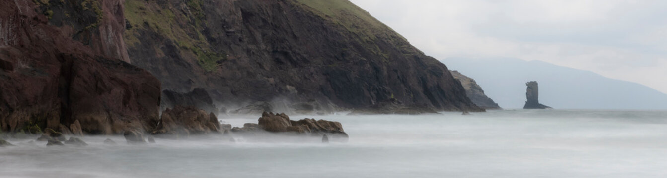 Ireland, County Kerry, Dunmore Head. Panoramic of cliff and fog on ocean and beach.