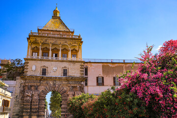 Palermo, Sicily. Porta Nuova, old wall city gate, statue reliefs and bougainvillea