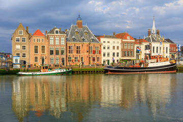 Netherlands, Zuid Holland, Maassluis. Harbor boats and row houses.