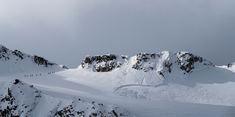 Svalbard, Norway. Group of skiers skirting a recent avalanche.