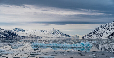 Svalbard, Norway. Panoramic landscape of blue ice sheets, mountains and bay.