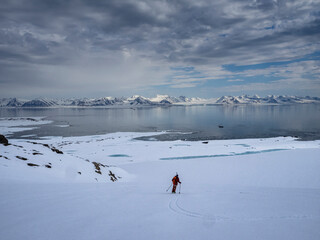 Svalbard, Norway. Solo skier having a backcountry adventure.