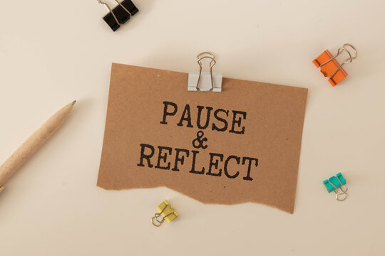 Blackboard written pause reflect with alarm clock. Pause and reflect word