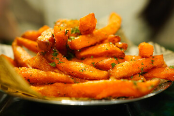 Closeup of  sweet potato fries seasoned with salt and herbs 