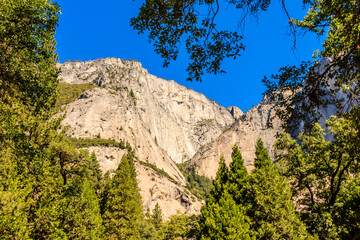 A mountain range with a blue sky in the background