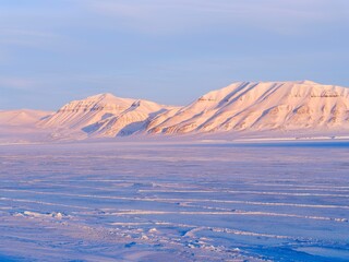 View over frozen Billefjorden towards mountains of Sassen-Buensow Land National Park. Winter...