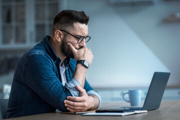 Attractive tired bored programmer digital specialist manager work remotely online overtime....