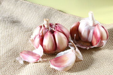 Garlic bulbs on the jute fabric. Brazilian spices. Typical ingredient present in brazilian culinary.