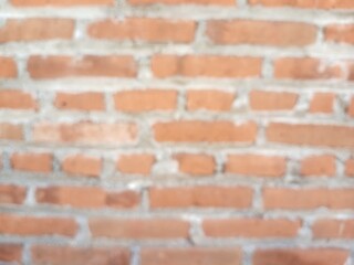 Defocused abstract background of red brick wall.