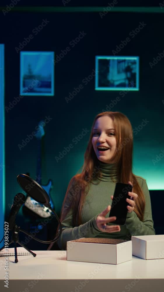 Poster vertical video gen z content creator filming technology review of newly released smartphone, unpacki