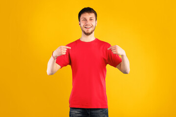 Choose Me. Egocentric male pointing at him self, wearing blank t-shirt for your text or promotional...