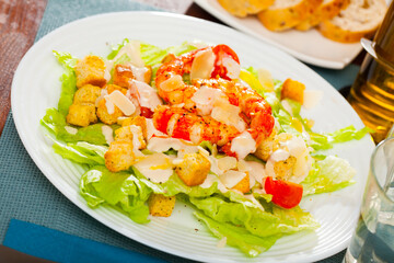 Caesar salad on plate at restaurant