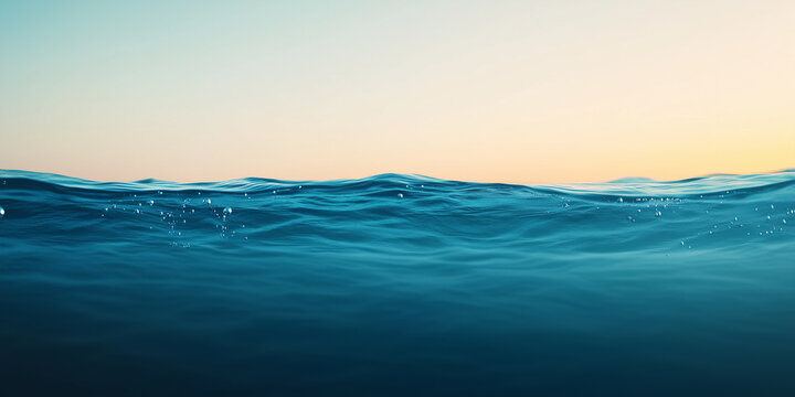 Calm ocean waves under serene sunset sky create tranquil atmosphere.