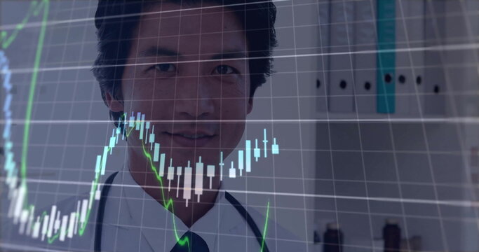 Image of financial data processing over asian male doctor in hospital - Powered by Adobe