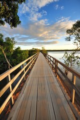 Fototapeta premium Long Wooden Pier Amidst Lush Greenery at Sunset Before Vibrant Sky : Generative AI