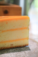 Orange cake on wooden table. Citrus cake by classic recipe. Homemade bakery, vegan dessert.