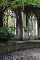 Gothic ruins of St Dunstan in the East Church Garden, adorned with lush greenery and cobblestone pathways, a hidden gem in the heart of London, England, United Kingdom.