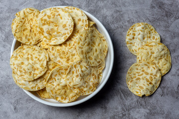 keripik tempe or tempeh chips are made from soybeans and served on white plate
