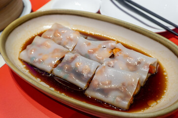hong kong dim sum - chee cheong fun, thiny steamed rice flour wrapped with assorted ingredients...