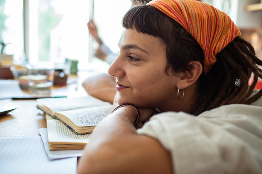 Close up of a young woman studying and reading a book with focus
