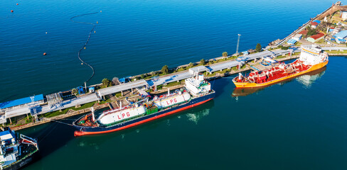LPG tankers moored at industrial marine terminal for cargo loading, showcasing global energy logistics and maritime transportation infrastructure.