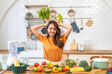 Portrait of beauty body slim healthy asian woman eating vegan food healthy with fresh vegetable salad in kitchen at home.diet, vegetarian, fruit, wellness, health, green food.Fitness and healthy food