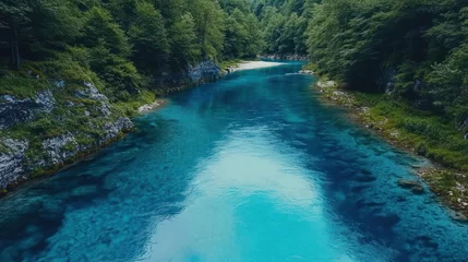 Fototapete Turquoise river flows through forested canyon. © arsyi_06