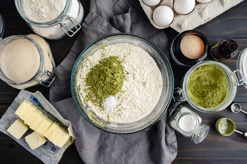 Unmixed Dry Ingredients for Matcha Bread: Flour, green tea powder, sugar, and salt in a glass...