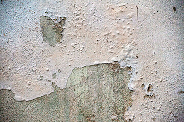Exterior stucco on an old house is damaged. Exterior finish.