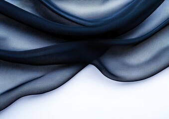 A close-up of flowing sheer fabric with intricate patterns, showcasing delicate textures in shades of black and gray against a light background.
