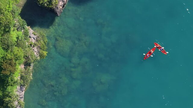 Experience the breathtaking aerial view of longtail boats gracefully gliding through Krabis crystalclear turquoise waters, showcasing Thailands iconic, diverse, and beautiful coastline