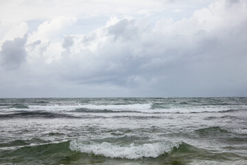 A tropical storm accompanied by rain came from the Indian Ocean accompanied by gloomy dark cloudy skies, turbulent sea waves around the coast.