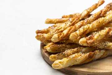 Golden Puff Pastry Sticks with Sesame and Chia Seeds on White Background