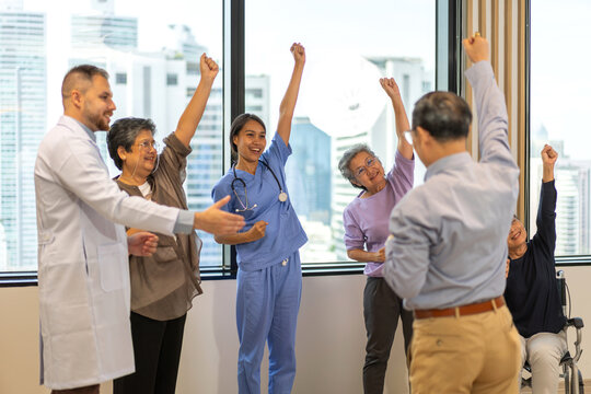 Group therapy session for asian seniors with physiotherapist, physical rehabilitation for elderly, senior fitness program group exercises, health and wellness for elderly physical therapy exercises