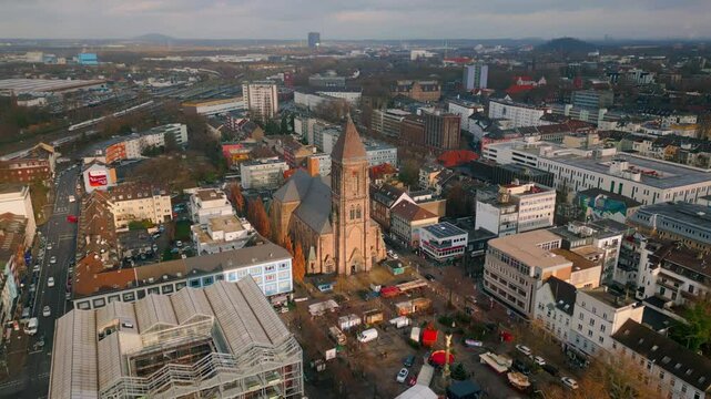 Aerial view of Herz Jesu Church standing at the center of Oberhausen, Germany. Surrounded by modern urban life, the church serves as a timeless landmark connecting history and the city&rsquo;s growth.
