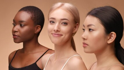 Three women of different backgrounds pose together, highlighting their distinct features and natural beauty. The soft lighting emphasizes their skin tones and expressions gently.