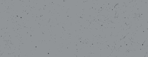 Gray background with a gray speckled texture. The background features a minimalist, grunge style with scattered dark specks. Paper texture background vector. Gray background.