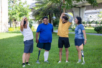 Portrait of people with leg amputated in stretching exercise at the urban public park together with...