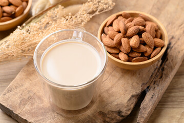 Almond milk in cup glass on wooden background, Alternative milk made from plant, non dairy