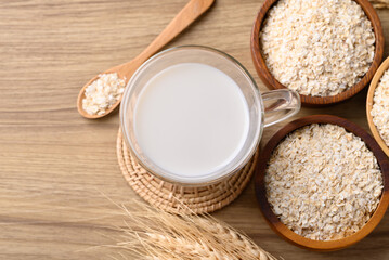 Oat milk in cup glass on wooden background, Alternative milk made from plant, non dairy