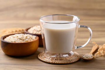 Oat milk in cup glass on wooden background, Alternative milk made from plant, non dairy