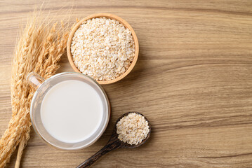 Oat milk in cup glass on wooden table, Alternative milk made from plant, non dairy