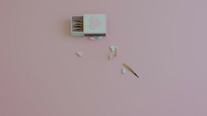 Broken heart candies scattered randomly near an open matchbox